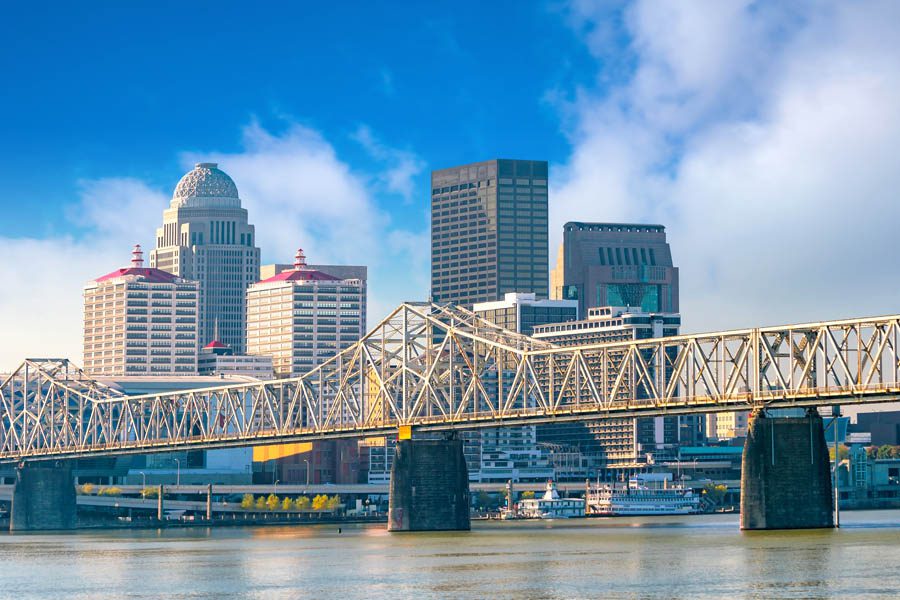 Louisville, KY Insurance - Louisville Skyline with the Bridge Leading into the City Looking Over the Water